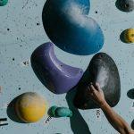 a person holding a grip on wall