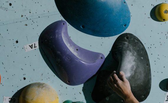 a person holding a grip on wall